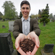 Katrina Spade, the founder and CEO of Recompose, showing off the wood shavings and other plant mulch used to help bodies compost in a photo taken in April 2019
